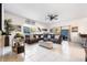 Bright living room featuring tile floors, a ceiling fan, and a comfortable brown sectional sofa at 18127 Sandy Pointe Dr, Tampa, FL 33647