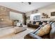 Spacious living room showcases a dark wood accent wall and a comfortable sectional sofa at 18127 Sandy Pointe Dr, Tampa, FL 33647
