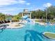 Aerial view of a large pool with a water slide and surrounding lounge chairs on a sunny day at 18127 Sandy Pointe Dr, Tampa, FL 33647
