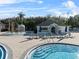 View of a sparkling pool featuring a water feature, sun umbrellas and comfortable lounge chairs for relaxation at 18127 Sandy Pointe Dr, Tampa, FL 33647