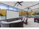 Spacious screened-in room featuring outdoor furniture, a movie screen, and fans at 18127 Sandy Pointe Dr, Tampa, FL 33647