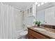 Updated bathroom with granite vanity, shower/tub combo, and white tile at 201 W Laurel St # 503, Tampa, FL 33602