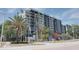 Exterior view of a multi-story building with palm trees and landscaping at 201 W Laurel St # 503, Tampa, FL 33602