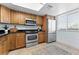 Modern kitchen with stainless steel appliances and wood cabinets at 201 W Laurel St # 503, Tampa, FL 33602