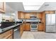 Modern kitchen with stainless steel appliances and wood cabinets at 201 W Laurel St # 503, Tampa, FL 33602