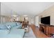 Spacious living room with sectional sofa and hardwood floors, open to dining area at 201 W Laurel St # 503, Tampa, FL 33602