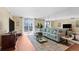 Bright living room with comfy sectional sofa, large windows, and hardwood floors at 201 W Laurel St # 503, Tampa, FL 33602