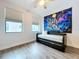 Bright bedroom featuring wood flooring and large windows at 2511 N Grady N Ave # 59, Tampa, FL 33607