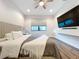 Bright bedroom with large TV, wood floors, and ceiling fan at 2511 N Grady N Ave # 59, Tampa, FL 33607