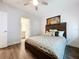 Spacious bedroom with wood-look floors and ensuite bathroom access at 2511 N Grady N Ave # 59, Tampa, FL 33607