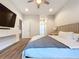 Spacious bedroom with large bed, wood floors, and ceiling fan at 2511 N Grady N Ave # 59, Tampa, FL 33607