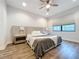 Spacious bedroom with large bed, wood floors, and ceiling fan at 2511 N Grady N Ave # 59, Tampa, FL 33607