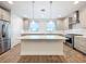 Modern kitchen with white quartz countertops and island at 2511 N Grady N Ave # 59, Tampa, FL 33607