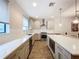 Modern kitchen with quartz countertops, stainless steel appliances, and ample cabinet space at 2511 N Grady N Ave # 59, Tampa, FL 33607