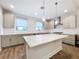 Modern kitchen with white quartz countertops and island at 2511 N Grady N Ave # 59, Tampa, FL 33607