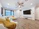 Bright living room featuring a sectional sofa and large TV at 2511 N Grady N Ave # 59, Tampa, FL 33607