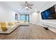 Open living room with hardwood floors, sectional, and large TV at 2511 N Grady N Ave # 59, Tampa, FL 33607