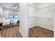 Large walk-in closet with wire shelving and wood floors at 2511 N Grady N Ave # 59, Tampa, FL 33607