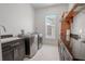 Laundry room with side-by-side washer and dryer, and granite countertop at 2711 W Trilby Ave, Tampa, FL 33611