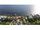 Aerial view of waterfront home with damaged roof and debris at 3219 Bayshore Ne Blvd, St Petersburg, FL 33703