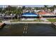 Damaged waterfront home with temporary roof covering at 3219 Bayshore Ne Blvd, St Petersburg, FL 33703