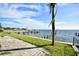 Relaxing patio area overlooking a calm waterfront with a boat dock at 3219 Bayshore Ne Blvd, St Petersburg, FL 33703