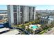 High-rise building with pool and parking; aerial view at 400 Island Way # 1411, Clearwater Beach, FL 33767