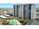 Aerial view showing building, pool, and waterfront location at 400 Island Way # 1411, Clearwater Beach, FL 33767