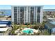Aerial view of a high-rise building with pool and parking at 400 Island Way # 1411, Clearwater Beach, FL 33767