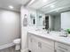 Double vanity bathroom with modern white cabinets and quartz countertop at 400 Island Way # 1411, Clearwater Beach, FL 33767