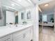 Modern bathroom with white vanity, quartz countertop, and mirrored medicine cabinets at 400 Island Way # 1411, Clearwater Beach, FL 33767