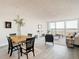 Light and airy dining area with wood table and four black chairs, overlooking city view at 400 Island Way # 1411, Clearwater Beach, FL 33767