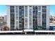 Front view of a tall, white residential building with parking at 400 Island Way # 1411, Clearwater Beach, FL 33767