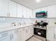 Modern white kitchen with stainless steel appliances at 400 Island Way # 1411, Clearwater Beach, FL 33767