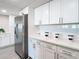 Sleek stainless steel refrigerator in a white kitchen with updated cabinetry at 400 Island Way # 1411, Clearwater Beach, FL 33767