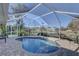 Kidney-shaped pool with a screened enclosure, surrounded by a paved patio at 4309 Meadowland Cir, Sarasota, FL 34233