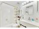 White bathroom with tile walls, shower/tub combo, and vanity at 5201 Pless Rd, Plant City, FL 33565