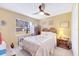 Cozy bedroom with wooden furniture, ceiling fan, and window with blinds at 5201 Pless Rd, Plant City, FL 33565