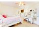 A cozy bedroom with a white bed, vanity, and decorative accents at 5201 Pless Rd, Plant City, FL 33565