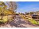 Paved driveway lined with a wooden fence leading to a house on a large property at 5201 Pless Rd, Plant City, FL 33565