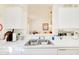 The kitchen features white cabinets, a double sink, and a view into the dining area at 5201 Pless Rd, Plant City, FL 33565