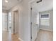 Bright hallway with light gray walls and wood-look flooring at 5508 Rainwood Meadows Dr, Apollo Beach, FL 33572