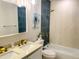 Spa-like bathroom with double vanity, teal tile, and a bathtub at 5516 Golden Dr, Tampa, FL 33634