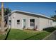 Newly built home showcasing a modern design with a light gray exterior and a green front door at 5516 Golden Dr, Tampa, FL 33634