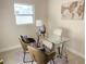 Home office with glass desk, two chairs and globe at 5516 Golden Dr, Tampa, FL 33634