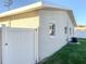 Exterior view of the house showcasing a light-colored wall and a white fence at 5516 Golden Dr, Tampa, FL 33634