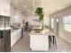 Open kitchen with large island, white cabinets, and stainless steel appliances at 5516 Golden Dr, Tampa, FL 33634