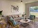 Bright living room featuring a beige sofa and accent chairs at 5516 Golden Dr, Tampa, FL 33634