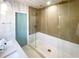 Walk-in shower with frameless glass enclosure and marble flooring at 5516 Golden Dr, Tampa, FL 33634