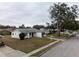 Single story house with red door and attached garage, street view at 5601 Lima Dr, Holiday, FL 34690